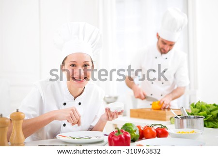 View of a Young attractive professional chef cooking in his kitchen