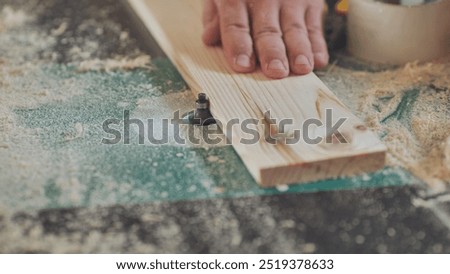 Similar – Image, Stock Photo Skilled woodworker using milling machine while working with lumber in contemporary workroom