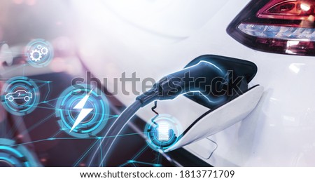Electric car power cable plugged into car charging station booth futuristic modern technology loading electricity energy, power supply battery charge energy electro mobility eco environment-friendly 