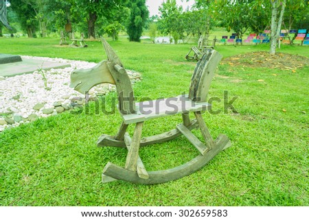 Old rocking horse on a rustic country backdrop.