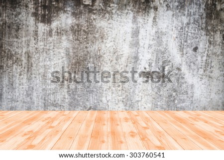 Wood table top on blurred background of  Vintage wall in industrial building with light from corner - can be used for display or montage your products