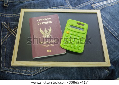 thailand passport and calculator on jean texture background