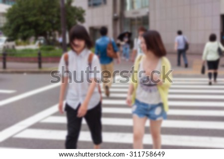 abstract blurred background  People walk across the crosswalk On the street in Osaka, Japan.