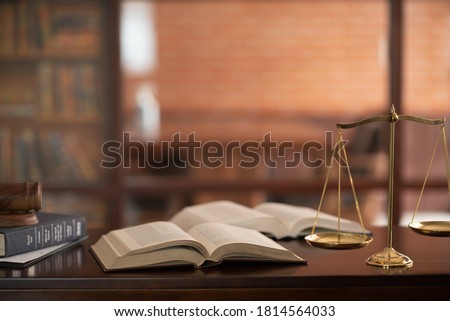law books and scales of justice on desk in library of law firm. jurisprudence legal education concept. ストックフォト © 