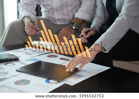business team using laptop computer with financial report spreadsheet virtual screen interface for business and marketing research evaluation performance. Stockfoto © 