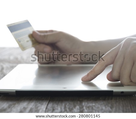 close-up women\'s hand using tablet pc for shopping online.