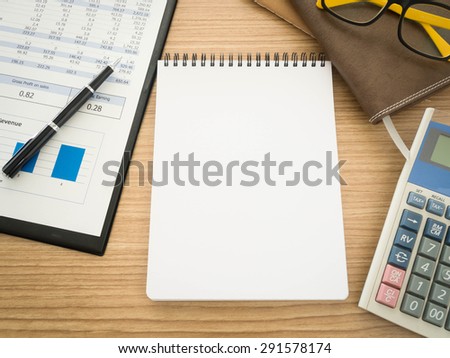Notebook on the desk with the analysis report , Pens, calculators.