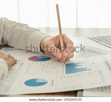 Businessmen are analyzing the data from the report.