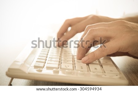 human\'s hands typing on computer keyboard. selective focus.