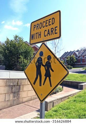 yellow and black \'proceed with care\' sign at aged care facility
