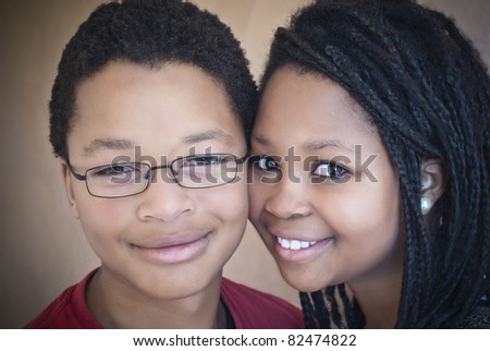 Two attractive African American teenagers. One male, one female.