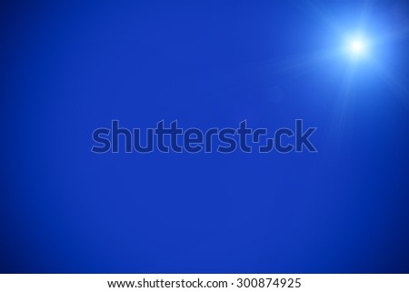Clear blue sky sun light with Real Lens flare out of focus