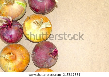 Red and white onion on a wooden background