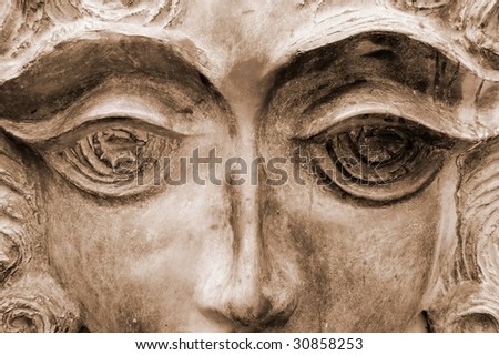 Face of female sculpture with bronze tone.