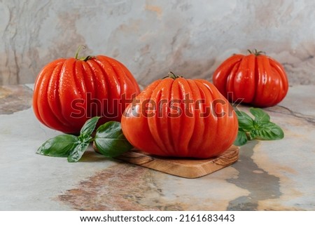 Fresh Raf Coeur De Boeuf tomatoes and basil on a brown background, rustic concept, stock photo Zdjęcia stock © 