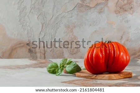 Fresh Raf Coeur De Boeuf tomato and basil on a brown background, rustic concept, space for text, stock photo Zdjęcia stock © 