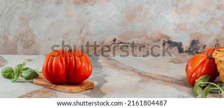 Fresh Raf Coeur De Boeuf tomatoes and basil on a brown background, restaurant concept, space for text, stock photo Zdjęcia stock © 