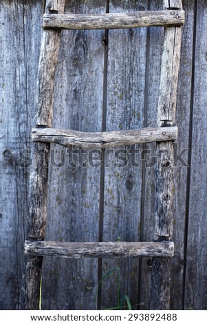 Old wooden ladder on old wooden wall