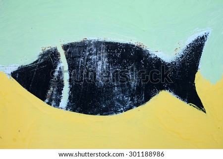 Painted concrete wall with painted black fish, abstract background