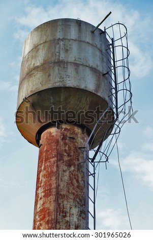 Old rusty water tower in village, Russia.