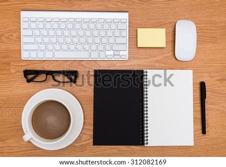 Office stationery accessories  desk from  top view with brown wood background / Mix of office supplies and gadgets on a wooden desk background.
