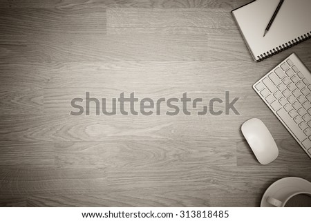 Office table with notepad, mouse,keyboard,coffee,with wood desk texture background. View from above with bottom copy space .black and white vintage color tone style / clean desk from top view