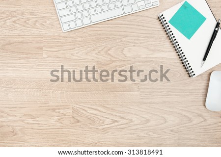 Office table with notepad, mouse,keyboard with wood desk texture background. View from above with bottom copy space / clean desk from top view