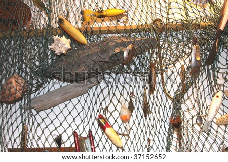 Fishing net full of vintage fishing lures and driftwood