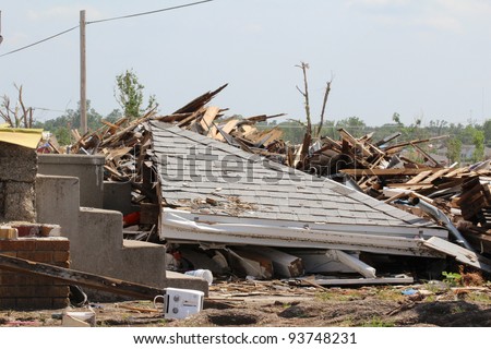 A portion of the roof of this house has collapsed onto the homes remains after an EF5 tornado ripped through the area, causing destruction of historic proportion.