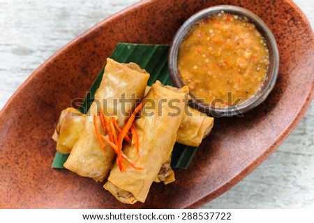 Indonesian-style spring rolls served with sambal dipping sauce and red chillies.
