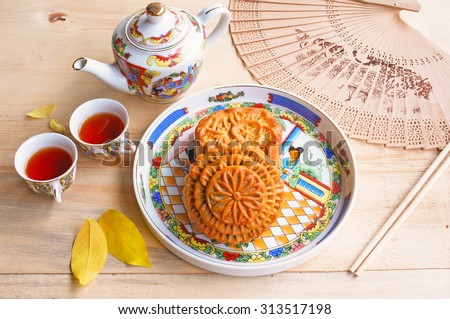 Moon cake and tea set on wooden table, Chinese mid-autumn food festival