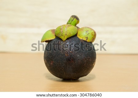 Mangosteen on wooden floor.Fresh Fruits.