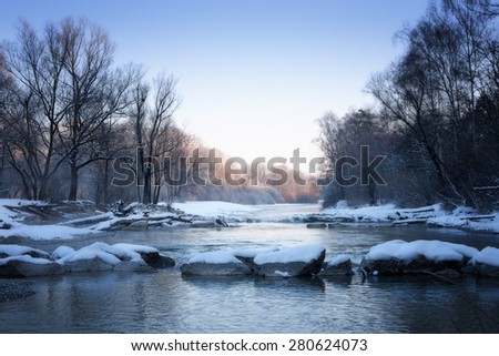 The river in the winter at sunset. Winter landscape. Winter wonderland. Winter background.