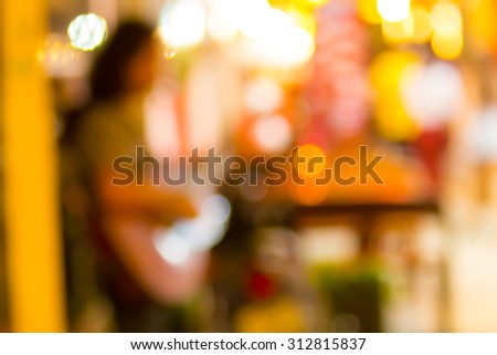 Life must fight. Blurry shot of street musician playing guitar and mouth organ at night market of Bangkok Thailand.