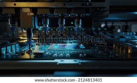 Automatic Pick and Place machine quickly installs Components on Circuit Board. Electronics and Circuit board Manufacturing. Dark Environment ストックフォト © 