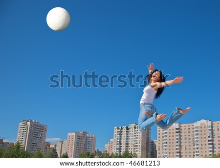 White ball and  jump of the young sports girl  on the urban background