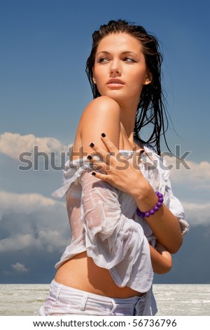 Portrait of beautiful sexy girl in wet white shirt