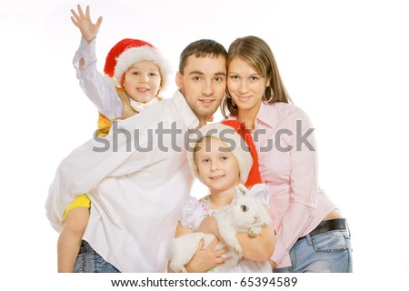 Family portrait of happy parents and children with white bunny.