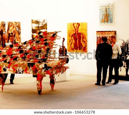 MILAN - MARCH 27: People walk through work of arts galleries during MiArt ArtNow, international exhibition of modern and contemporary art March 27, 2010 in Milan, Italy.