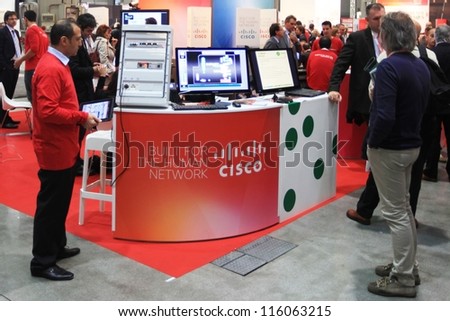 MILAN, ITALY - OCTOBER 17: People at Cisco technology products exhibition area at SMAU, international fair of business intelligence and information technology October 17, 2012 in Milan, Italy.