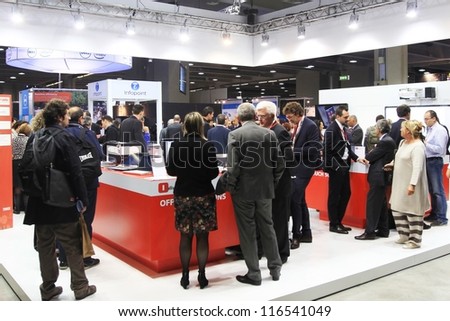 MILAN, ITALY - OCTOBER 17: People visit technology products exhibition area at SMAU, international fair of business intelligence and information technology October 17, 2012 in Milan, Italy.