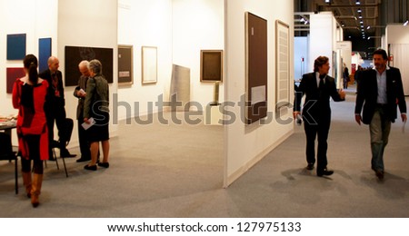 MILAN - MARCH 27: People look at paintings gallery during MiArt ArtNow, international exhibition of modern and contemporary art March 27, 2010 in Milan, Italy.