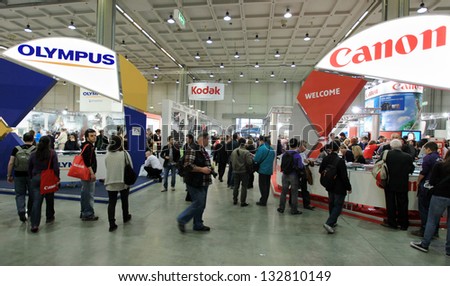 MILAN, ITALY - MARCH 26: People at tech stands looking for cameras, lenses and accessories at PHOTOSHOW, International Photo and Digital Imaging Exhibition on March 26, 2011 in Milan, Italy.