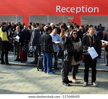 MILAN - APRIL 10: People at reception area during Salone del Mobile, international home furnishing design and accessories exhibition on April 10, 2013 in Milan, Italy.