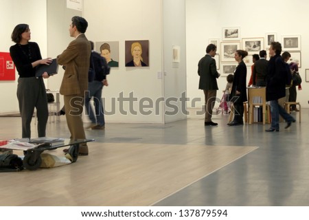 MILAN - APRIL 07: People talk while looking at paintings gallery at MiArt, international exhibition of modern and contemporary art April 07, 2013 in Milan, Italy.