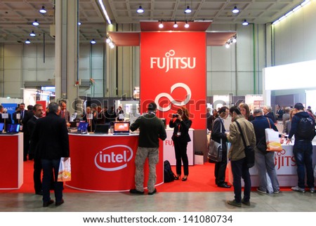 MILAN, ITALY - OCTOBER 17: People visit Fujitsu technology products exhibition area at SMAU, international fair of business intelligence and information technology October 17, 2012 in Milan, Italy.