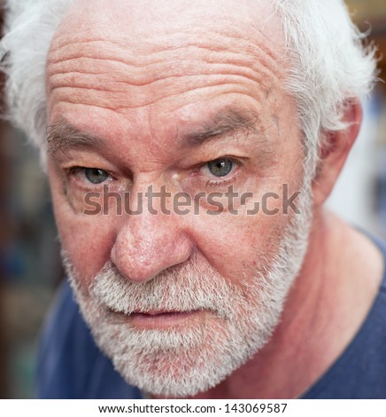 Portrait of caucasian man. Blue eyes, white beard, neutral expression.