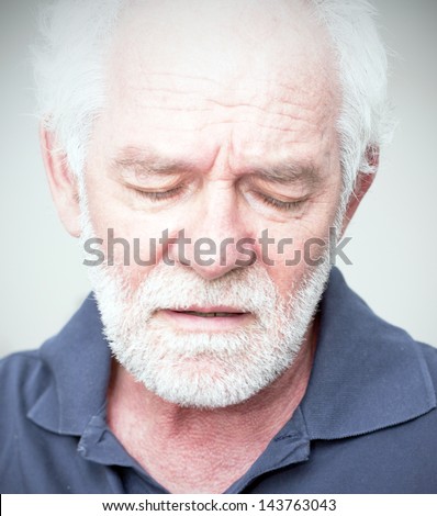 Sad man, looking down caucasian man with white beard