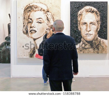 MILAN - APRIL 08: Women look at paintings representing Marilyn Monroe and Paul Newman during MiArt, international exhibition of modern and contemporary art on April 08, 2011 in Milan, Italy