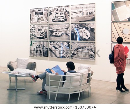 MILAN - APRIL 08: Woman look at paintings galleries during MiArt, international exhibition of modern and contemporary art on April 08, 2011 in Milan, Italy